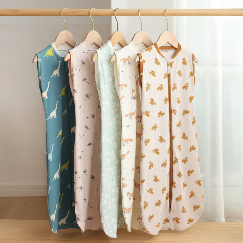 Four baby sleeping bags with animal patterns hanging on a rack, branded 'HOUSBAY'.